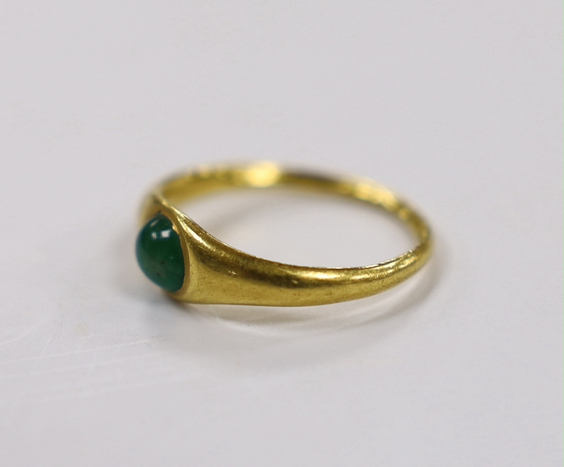A Roman high carat yellow metal and single stone cabochon emerald set ring, size L, gross weight 3.7 grams, stone size approximately 6.9mm by 5.9mm.